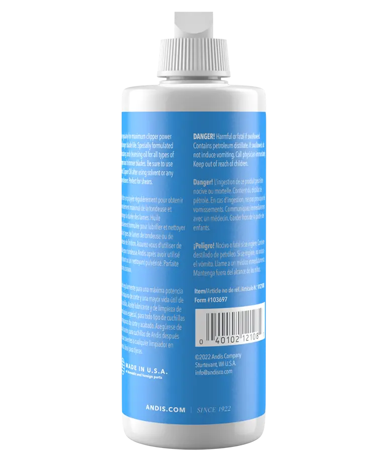 Andis 4oz clipper oil bottle showing the back label, used for lubricating hair clipper parts and maintaining their performance.
